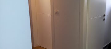 דלתות פנים לבנות בעיצוב קלאסי במסדרון הדירה